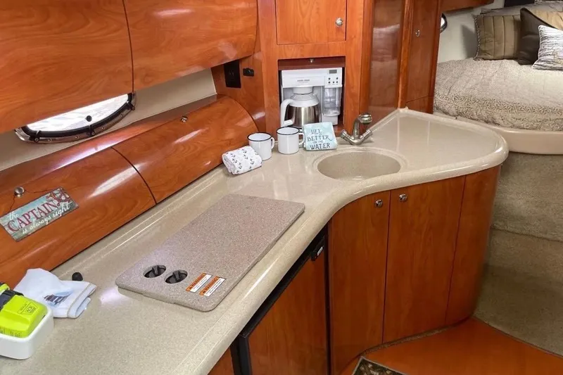 Slide: The Image of Interior of 2007 Larson Cabrio 350 yacht with kitchenette and cozy sleeping area. - 10