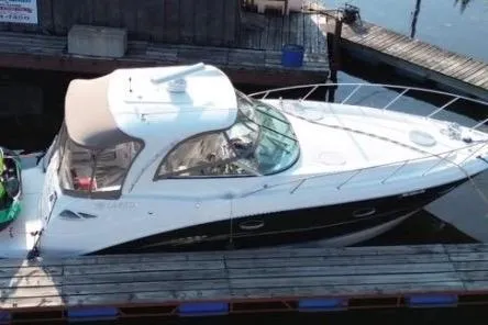 Slide: The Image of 2007 Larson Cabrio 350 boat docked at a marina, featuring sleek design and spacious cabin. - 4