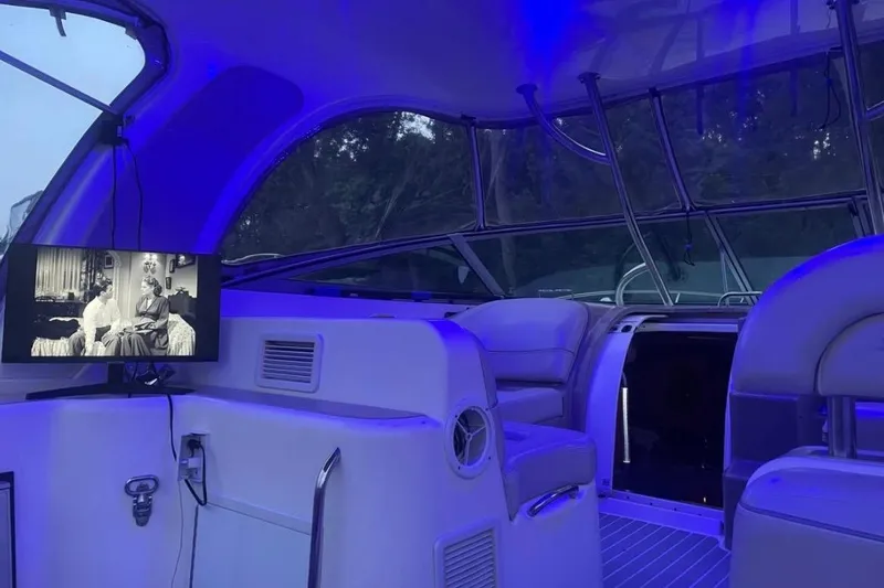 Slide: The Image of Interior of 2007 Larson Cabrio 350 boat with blue lighting and TV screen. - 7