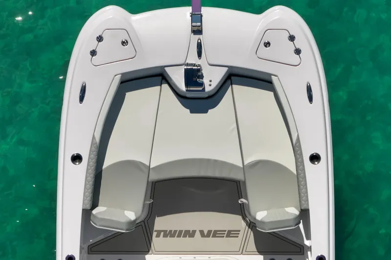Slide: The Image of 2026 Twin Vee 240 GFX CC boat, aerial view, white seating, turquoise water background. - 11