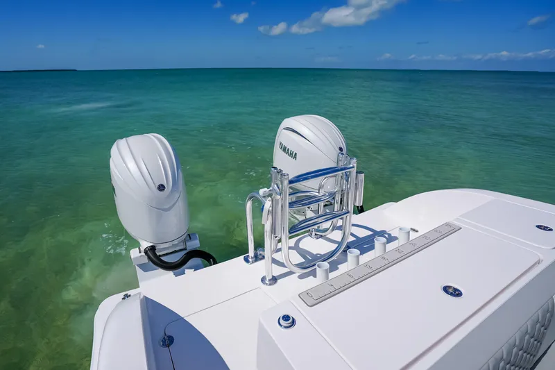 Slide: The Image of Twin Vee 240 GFX CC 2026 boat with Yamaha engines on clear ocean water. - 13