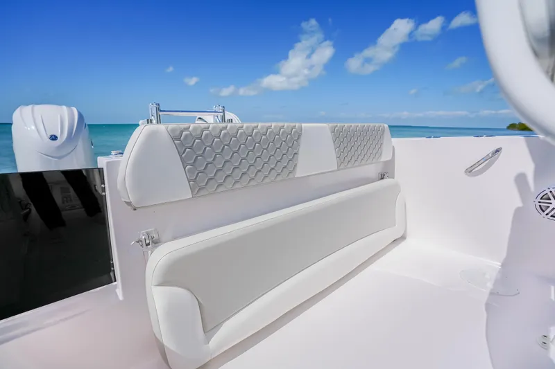 Slide: The Image of 2026 Twin Vee 240 GFX CC boat interior with cushioned seating, ocean view. - 15