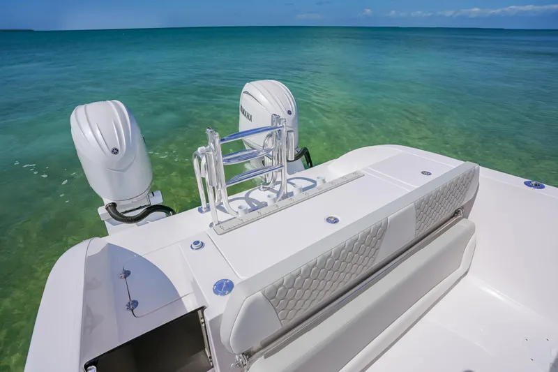 Slide: The Image of Twin Vee 240 GFX CC 2026 boat with dual engines on clear water. - 16