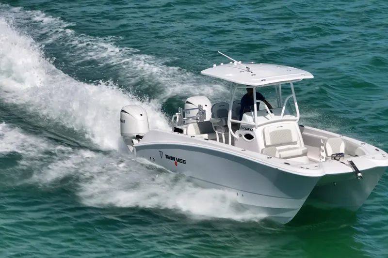 Slide: The Image of 2026 Twin Vee 240 GFX CC boat cruising on open water. - 2