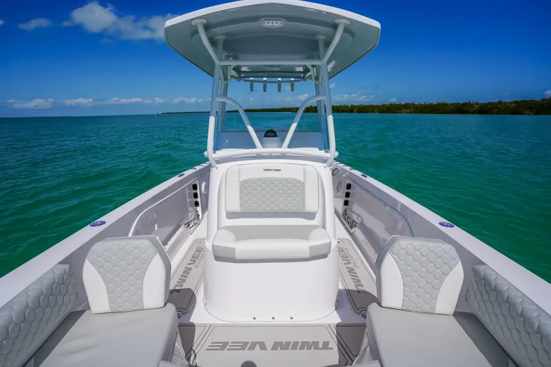 Slide: The Image of 2026 Twin Vee 240 GFX CC boat on turquoise water under clear blue sky. - 27