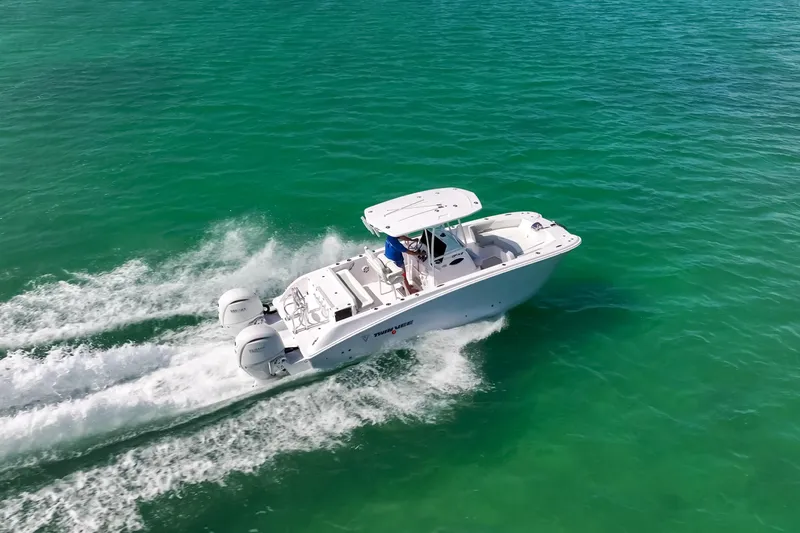 Slide: The Image of 2026 Twin Vee 240 GFX CC boat cruising on clear turquoise water. - 3