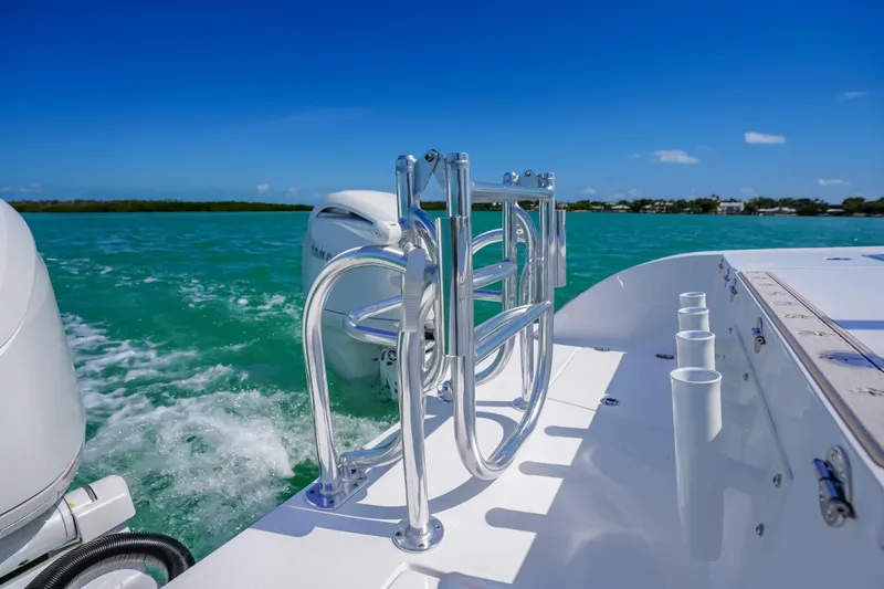 Slide: The Image of 2026 Twin Vee 240 GFX CC boat cruising on turquoise waters under clear blue sky. - 31