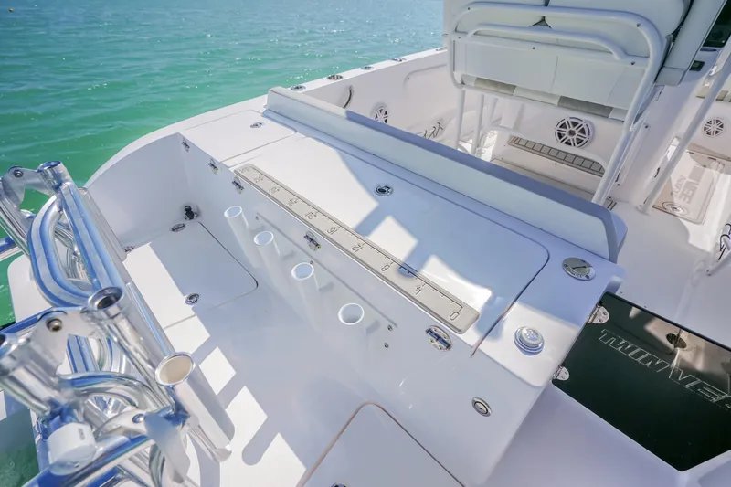 Slide: The Image of 2026 Twin Vee 240 GFX CC boat deck with fishing rod holders and seating. - 32