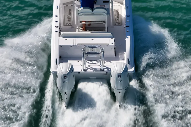 Slide: The Image of 2026 Twin Vee 240 GFX CC boat cruising on water with dual engines. - 4