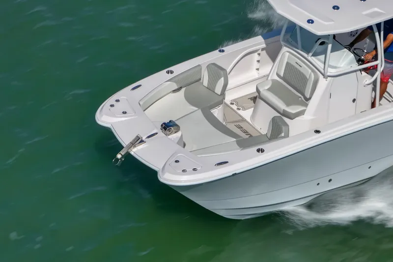 Slide: The Image of 2026 Twin Vee 240 GFX CC boat cruising on clear green water. - 5