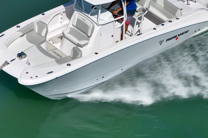 Slide: The Image of 2026 Twin Vee 240 GFX CC boat cruising on clear turquoise water. - 6
