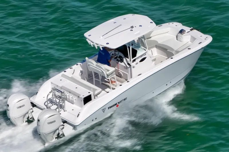 Slide: The Image of 2026 Twin Vee 240 GFX CC boat cruising on clear blue water. - 7