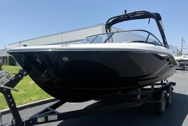 Slide: The Image of 2026 Bayliner V20i boat on trailer, sleek black design, parked outdoors. - 10