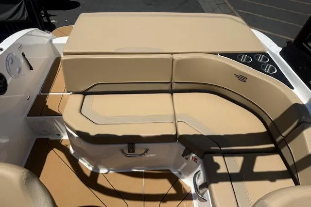 Slide: The Image of Luxurious seating area on 2026 Bayliner V20i boat with beige upholstery and cup holders. - 11