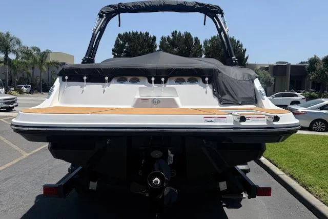 Slide: The Image of 2026 Bayliner V20i boat, rear view, parked outdoors on a sunny day. - 16