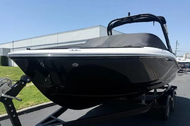 Slide: The Image of 2026 Bayliner V20i boat on trailer, sleek black design, outdoor setting. - 18