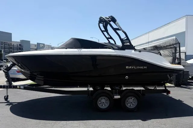 Slide: The Image of 2026 Bayliner V20i boat on trailer, sleek black design, parked outdoors. - 19