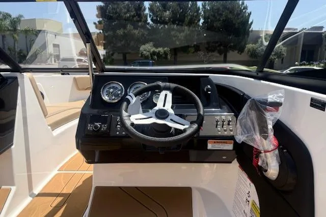 Slide: The Image of 2026 Bayliner V20i boat cockpit with steering wheel and control panel. - 21