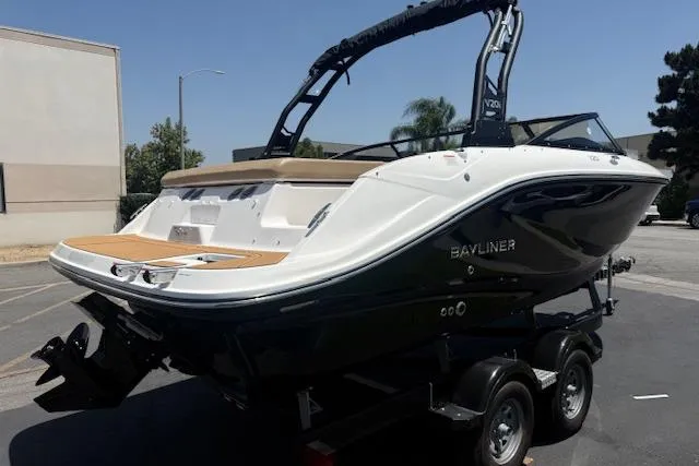 Slide: The Image of 2026 Bayliner V20i boat on trailer, sleek design, parked outdoors. - 23