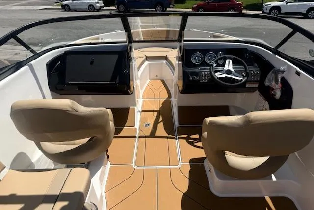 Slide: The Image of Interior view of 2026 Bayliner V20i boat with beige seating and modern dashboard. - 24
