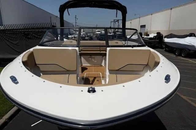 Slide: The Image of 2026 Bayliner V20i boat with spacious seating, docked outdoors. - 27