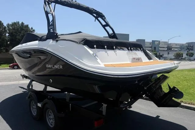 Slide: The Image of 2026 Bayliner V20i boat on trailer, sleek design, parked outdoors. - 29