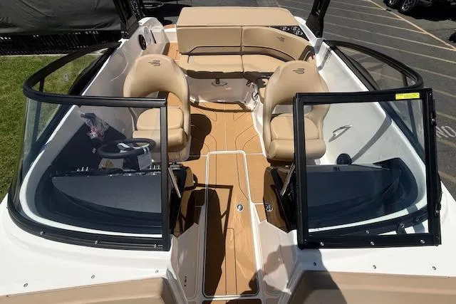 Slide: The Image of 2026 Bayliner V20i boat interior with tan seating and open windshield. - 3