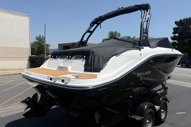 Slide: The Image of 2026 Bayliner V20i boat on trailer, black and white design, parked outdoors. - 30