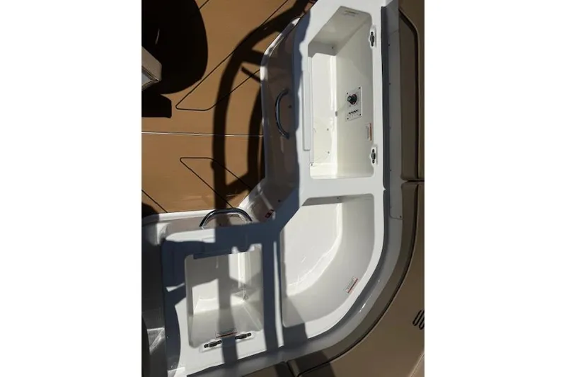Slide: The Image of 2026 Bayliner V20i boat interior with white seating and storage compartments. - 5