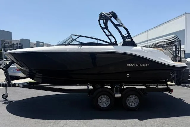 Slide: The Image of 2026 Bayliner V20i boat on trailer, sleek black design, parked outdoors. - 9