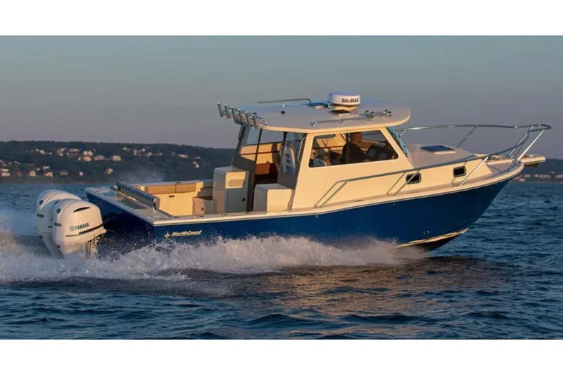 Slide: The Image of Manufacturer Provided Image: 2025 NorthCoast 315 HT boat cruising on water at sunset. - 2
