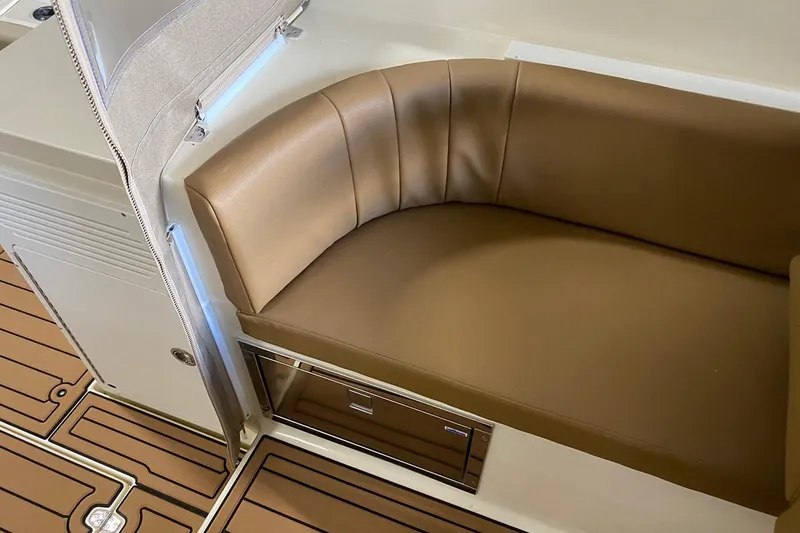 Slide: The Image of Manufacturer Provided Image: 2025 NorthCoast 315 HT boat interior with brown leather seating and wood-patterned flooring. - 9