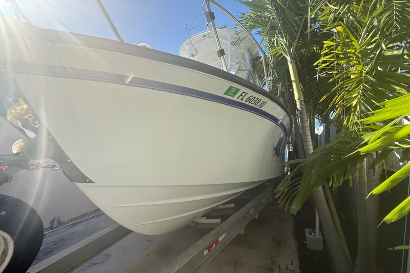 Slide: The Image of 1996 Grady-White Sailfish 272 boat on trailer, surrounded by palm trees. - 10