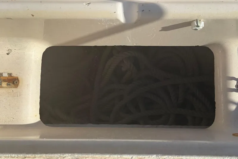 Slide: The Image of Storage compartment with coiled rope on a 1996 Grady-White Sailfish 272 boat. - 102