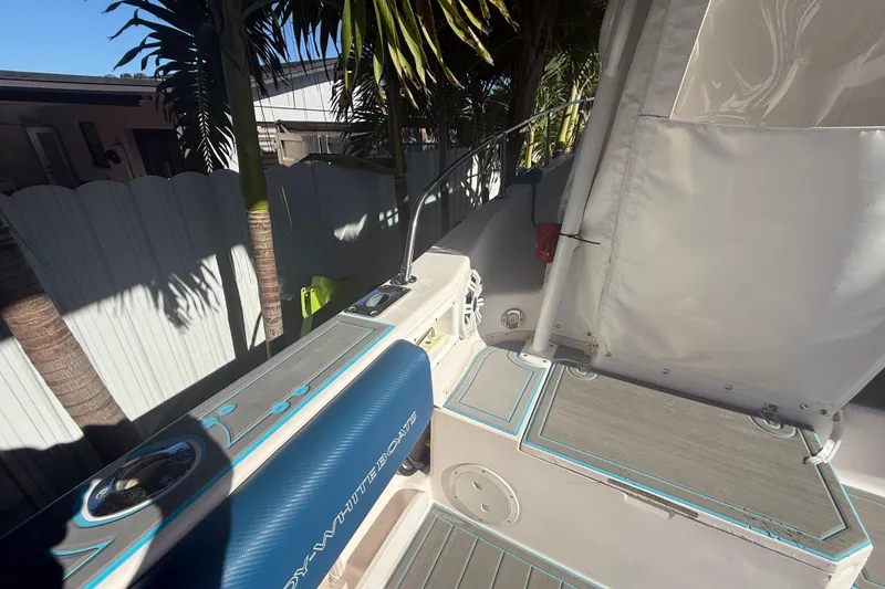 Slide: The Image of 1996 Grady-White Sailfish 272 boat interior with blue seating and white canopy. - 103