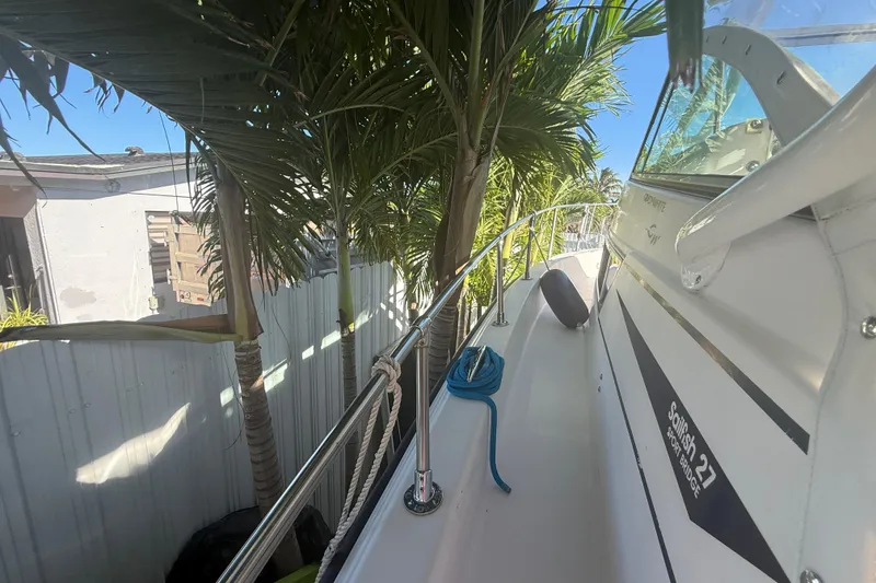 Slide: The Image of 1996 Grady-White Sailfish 272 boat docked near palm trees, side view. - 106