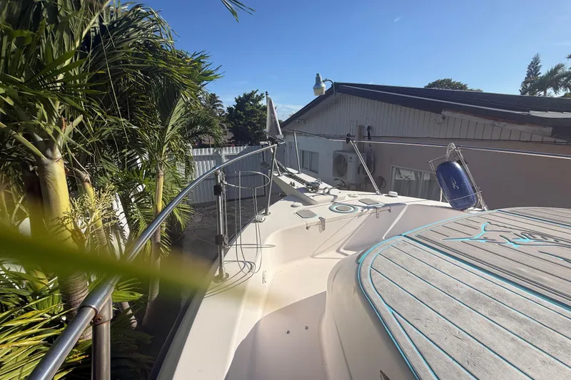 Slide: The Image of 1996 Grady-White Sailfish 272 boat deck with palm trees and house in background. - 112