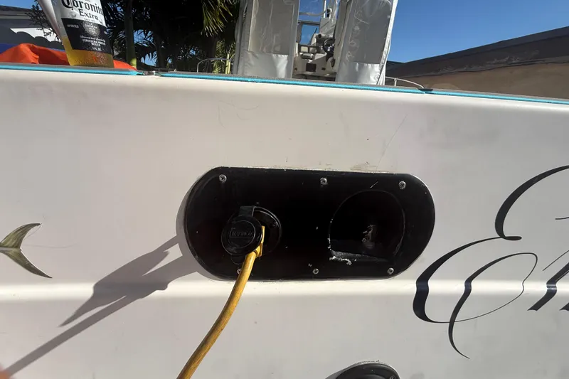 Slide: The Image of 1996 Grady-White Sailfish 272 boat with power connection and Corona beer bottle. - 115