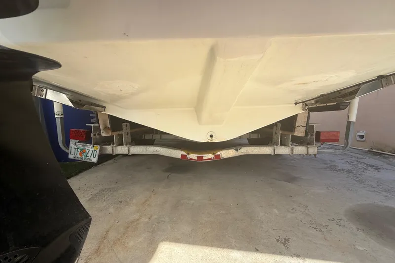 Slide: The Image of 1996 Grady-White Sailfish 272 boat on trailer, rear view, parked on concrete. - 117
