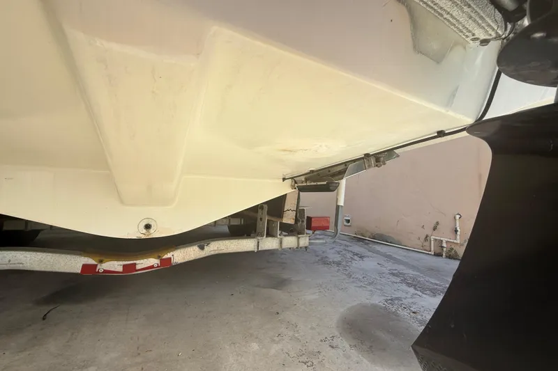 Slide: The Image of 1996 Grady-White Sailfish 272 boat underside on trailer, showing hull and propeller. - 118