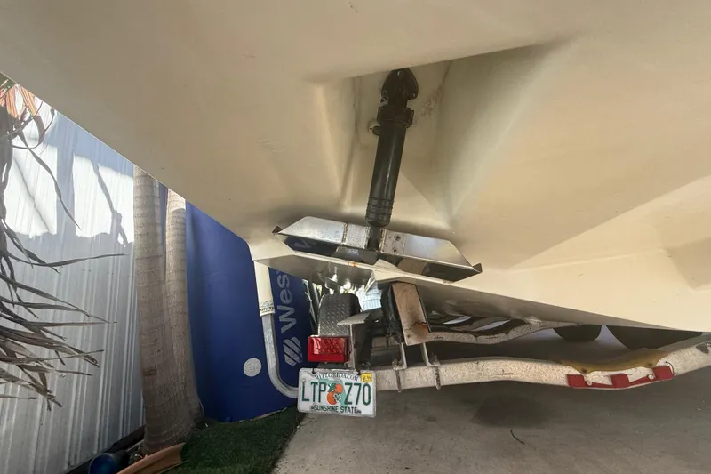 Slide: The Image of 1996 Grady-White Sailfish 272 boat underside with trailer and Florida license plate. - 122