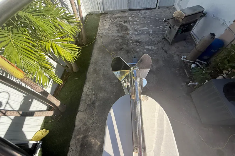 Slide: The Image of Overhead view of Grady-White Sailfish 272 anchor, 1996 model, near palm trees and patio. - 126
