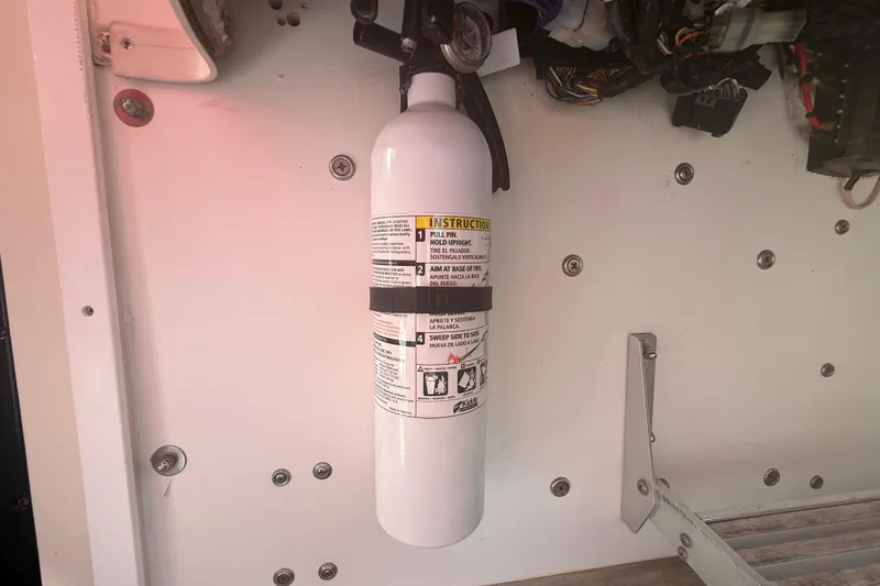 Slide: The Image of Fire extinguisher mounted on a 1996 Grady-White Sailfish 272 boat interior. - 129