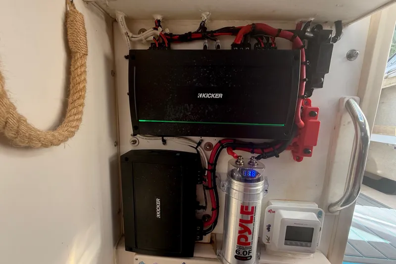 Slide: The Image of Audio system setup on a 1996 Grady-White Sailfish 272 boat, featuring Kicker amplifiers and Pyle capacitor. - 130