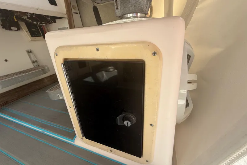 Slide: The Image of 1996 Grady-White Sailfish 272 boat interior with storage compartment and speaker. - 131