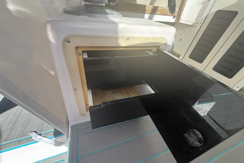Slide: The Image of 1996 Grady-White Sailfish 272 boat interior storage compartment with open hatch. - 132