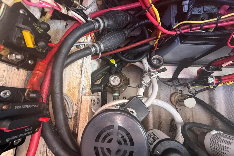 Slide: The Image of Engine compartment of a 1996 Grady-White Sailfish 272 with wiring and components. - 134