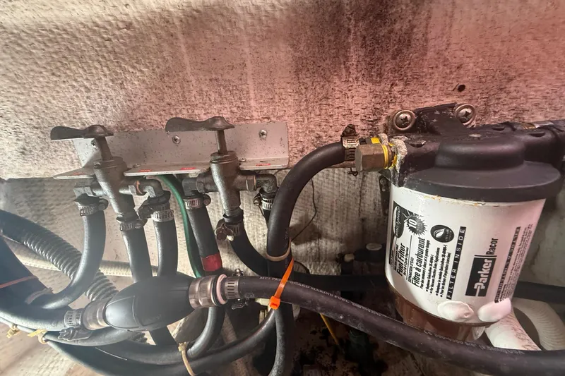 Slide: The Image of Engine compartment of a 1996 Grady-White Sailfish 272 with fuel lines and filter system. - 137