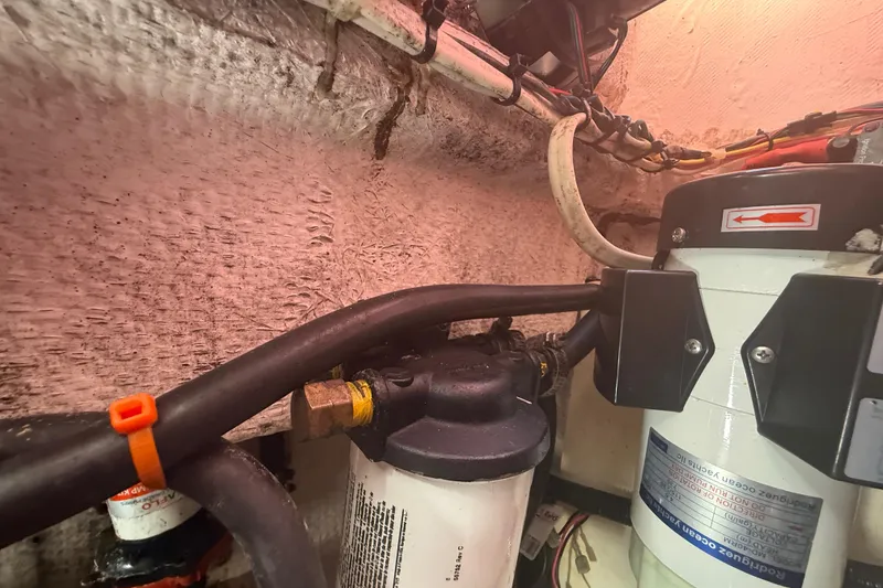 Slide: The Image of Engine compartment of a 1996 Grady-White Sailfish 272 boat, showing fuel filter and wiring. - 138