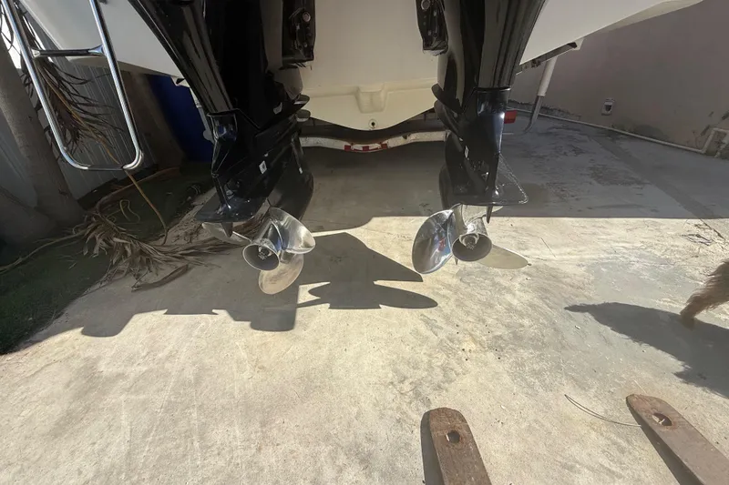 Slide: The Image of Twin outboard motors on a 1996 Grady-White Sailfish 272 boat, parked on concrete. - 18